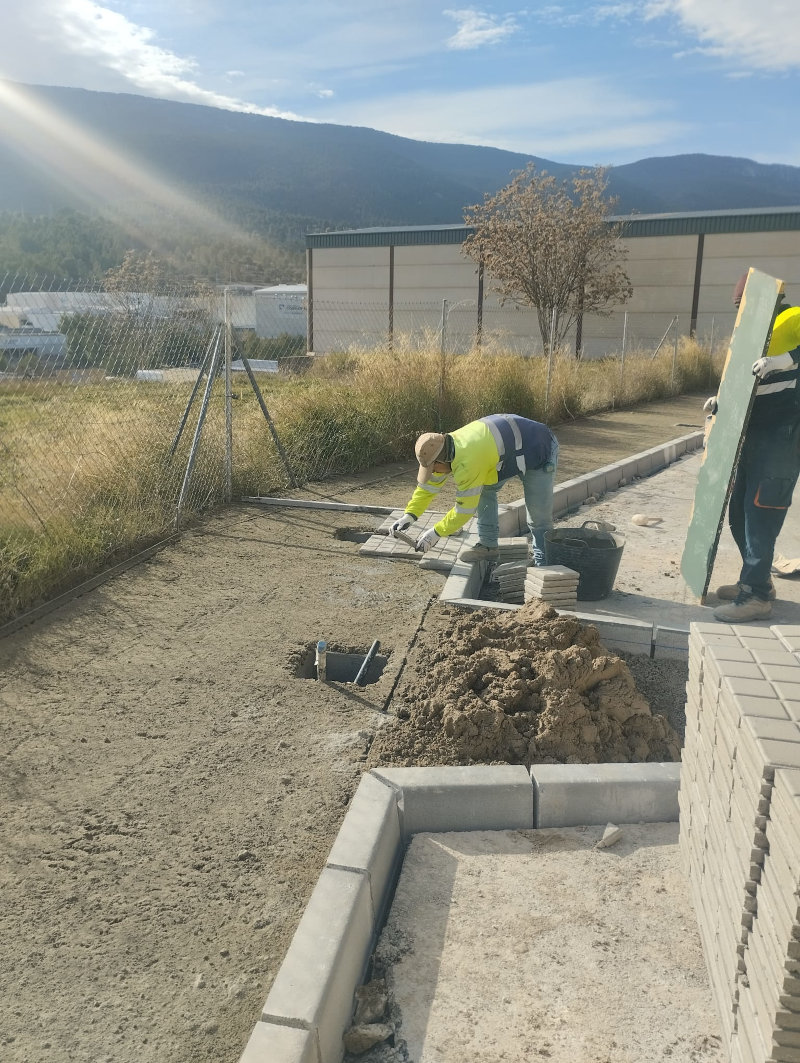 Operari col·locant les rajoles d'una vorera en el polígon El Castellar