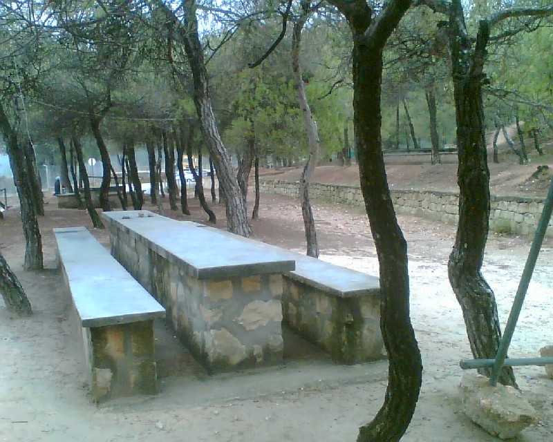 Mesas rectangulares y bancos de piedra
